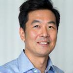 カーケア部門長である佐藤健太の肖像写真